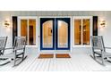Inviting front porch featuring rocking chairs and double doors at 220 Topside, Sanford, NC 27332