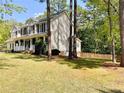 Charming home with a cozy front porch and a lovely landscaped yard with mature trees at 259 Sandpiper Dr, Sanford, NC 27332