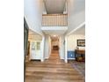 Inviting foyer with high ceilings, hardwood floors, and a view of the second-floor landing at 259 Sandpiper Dr, Sanford, NC 27332