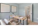 A bright bedroom featuring neutral decor and a view into the hallway at 274 Maddox Dr, Aberdeen, NC 27526