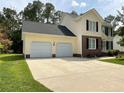 Well-kept two-story home featuring a two-car attached garage and wide driveway at 284 Coachman Way, Sanford, NC 27332