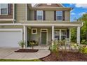 Inviting front porch with seating, enhancing the appeal of this charming two-story home at 296 Birch Ave, Spring Lake, NC 28390