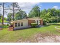 Inviting ranch-style home with a well-kept lawn and mature trees, close to a lake at 3000 Currituck Dr, Sanford, NC 27332