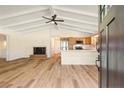 Open-concept living space featuring a fireplace, wood floors, ceiling fan and eat-in kitchen at 3000 Currituck Dr, Sanford, NC 27332