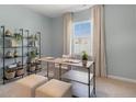 Serene bedroom featuring soft blue walls, a large window, and minimalist décor at 658 Wilder Bloom Path, Aberdeen, NC 27526