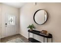 Welcoming entryway with a stylish round mirror, console table, and decorative rug at 658 Wilder Bloom Path, Aberdeen, NC 27526