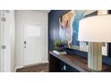 Elegant entryway featuring a white front door, wood floors, and stylish accents at 664 Wilder Bloom Path, Aberdeen, NC 27526