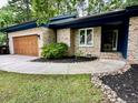 Charming single-story home featuring a large garage, a beautifully landscaped front yard, and an entryway at 75 Port Tack, Sanford, NC 27332