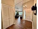 Inviting foyer with hardwood floors, coat closet, chandelier and natural light, creating a warm welcome at 75 Port Tack, Sanford, NC 27332