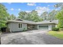 Charming home exterior with attached garage and inviting driveway, blending convenience and aesthetic appeal at 95 Fairway Ln, Sanford, NC 27332