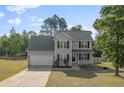 Charming two-story home with a two-car garage, well-manicured lawn, and classic black shutters at 140 Chinkapin Oak Cir, Bunnlevel, NC 28323