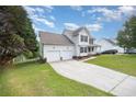 Spacious two-story home featuring an attached two-car garage and a driveway, ideal for convenient parking at 186 Yorkshire Dr, Cameron, NC 28326