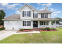 Charming two-story home featuring a welcoming front porch and a well-maintained lawn, perfect for curb appeal at 186 Yorkshire Dr, Cameron, NC 28326
