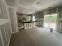 Bright kitchen with an island, modern cabinets, and sliding glass doors at 189 Travelers Way, Lillington, NC 27546