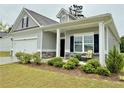 Charming one-story home with manicured landscaping, covered porch with a chair at 4939 Pioneer Dr, Sanford, NC 27330