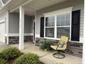 Inviting front porch with comfortable seating and decorative sunflower pillow at 4939 Pioneer Dr, Sanford, NC 27330