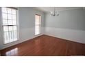 Bright dining room with hardwood floors, chair rail detail, and large windows providing natural light at 70 Ramsey Ct, Cameron, NC 28326
