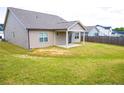 Spacious backyard with a well-maintained lawn and a covered patio area, great for outdoor enjoyment at 70 Waxflower Dr, Smithfield, NC 27577