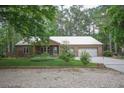 A single story brick home with a two-car garage and well maintained lawn at 129 Silver Lake Pt, Sanford, NC 27332