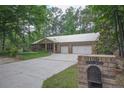 View of home and well manicured yard including the brick mailbox at the curb at 129 Silver Lake Pt, Sanford, NC 27332
