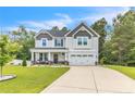 Charming two-story home with a well-manicured lawn and a welcoming front porch at 186 Old Glory Ln, Cameron, NC 28326