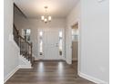 Elegant foyer with staircase, hardwood floors, and natural light at 203 Lake Edge Dr, Lillington, NC 27546