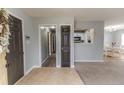 Open foyer with neutral paint, a combination of carpet and tile flooring, and views into other rooms at 2068 Tingen Rd, Broadway, NC 27505