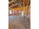 Unfinished interior with exposed framing, bright windows, and potential for customization at 214 Uwharrie Way, Sanford, NC 27330
