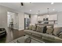 Relaxing living room featuring dark hardwood floors open to the kitchen and stainless steel appliances at 25 Glenside Ct, Spring Lake, NC 28390