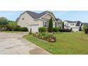 Well-manicured landscaping and a two-car garage highlight this charming single-Gathering home at 2817 Oxford Bluff Dr, Wake Forest, NC 27587