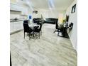 Open-concept layout with modern flooring, living room furniture, dining table, and an office desk at 3202 Finch Ct, Sanford, NC 27332