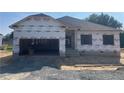 New construction home featuring an attached two-car garage during the building phase at 37 Shoreline Dr, Lillington, NC 27546
