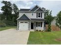 Charming two-story home with gray siding, black shutters, and a well-manicured lawn at 4161 Overhills Rd, Spring Lake, NC 28390