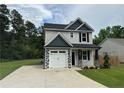 Charming two-story home with gray siding, black shutters, and a paved driveway at 4161 Overhills Rd, Spring Lake, NC 28390