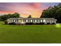 Charming single-story home with a well-maintained lawn and quaint porch, under a beautiful sunset sky at 99 Allen Brown Ln, Erwin, NC 28339