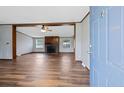 Open-concept living room boasts hardwood flooring, stone fireplace and abundant light from the many windows at 99 Allen Brown Ln, Erwin, NC 28339
