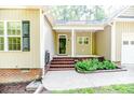 Inviting covered front porch with brick steps and columns at this lovely home at 1536 Louisiana Ln, Sanford, NC 27332
