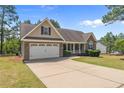 Charming single-Gathering home with a two-car garage and a well-manicured lawn at 16 Quail Holw, Sanford, NC 27332