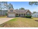 Inviting home with a well-maintained lawn, two-car garage, and classic design at 16 Quail Holw, Sanford, NC 27332