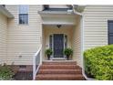 Inviting entryway featuring a brick staircase, elegant railing, and lush greenery at 24 Forest Hills Ct, Sanford, NC 27332