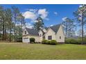 Lovely home with a well-kept lawn, mature trees, and an attached garage at 24 Forest Hills Ct, Sanford, NC 27332
