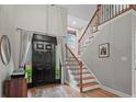 Bright foyer with hardwood floors, a staircase, and a stylish front door at 24 Forest Hills Ct, Sanford, NC 27332