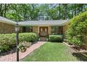 Inviting front entrance with double doors and well-maintained landscaping and brick walkway at 3113 Chipping Wedge, Sanford, NC 27330