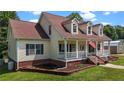 Side view of home featuring a well-manicured lawn, vinyl siding, and classic dormer windows at 4085 Alston Bridge Rd, Siler City, NC 27344