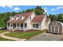 View of home with vinyl siding and a detached shed, offering both living space and ample storage at 4085 Alston Bridge Rd, Siler City, NC 27344