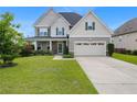 Charming two-story home with stone accents, a covered porch, and a well-maintained lawn at 415 Highgrove Highgrove Dr, Spring Lake, NC 28390