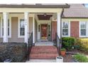 Charming front porch featuring brick steps, decorative elements, and a welcoming entrance to the home at 626 Orchard Falls Dr, Spring Lake, NC 28390