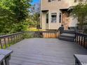 Spacious deck with gray railings and stairs leading to the front door at 70 Oregon Ln, Spring Lake, NC 28390