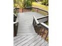 Spacious gray deck with railings overlooking the yard at 70 Oregon Ln, Spring Lake, NC 28390