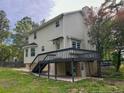 Back of home with a two-level deck, back yard, and lush, mature trees at 70 Oregon Ln, Spring Lake, NC 28390